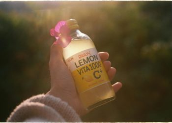 Hand Holding Lemon Beverage
