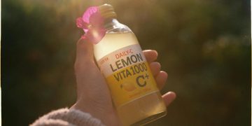 Hand Holding Lemon Beverage