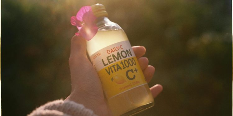 Hand Holding Lemon Beverage
