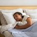 A woman sleeping in a bed with a blanket