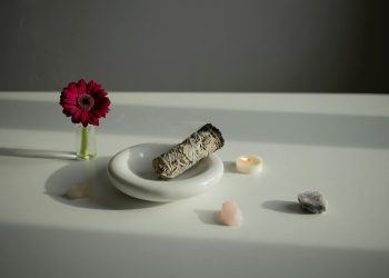 Incense on a White Plate, Crystals and a Gerbera Flower on a Table