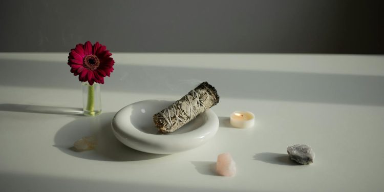Incense on a White Plate, Crystals and a Gerbera Flower on a Table
