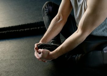 Strong Man Sitting on the Floor Stretching