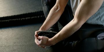 Strong Man Sitting on the Floor Stretching