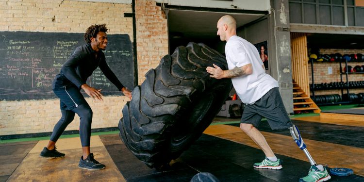 Man with a Prosthetic Leg Exercising at the Gym