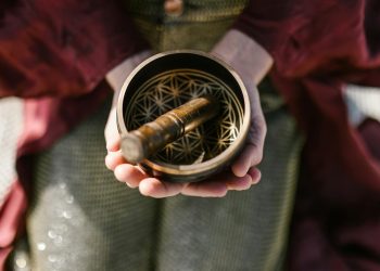 Person Holding a Singing Bowl