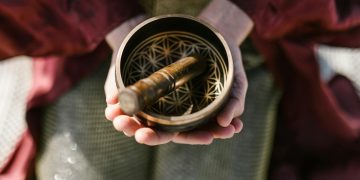 Person Holding a Singing Bowl