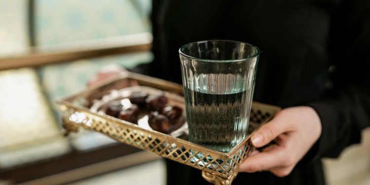 Glass of Water in a Metallic Serving Tray